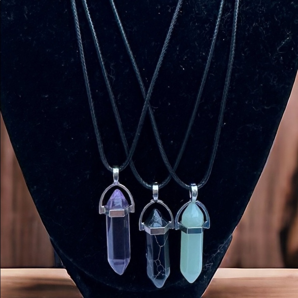 3 crystal pendant necklaces purple, black and green.